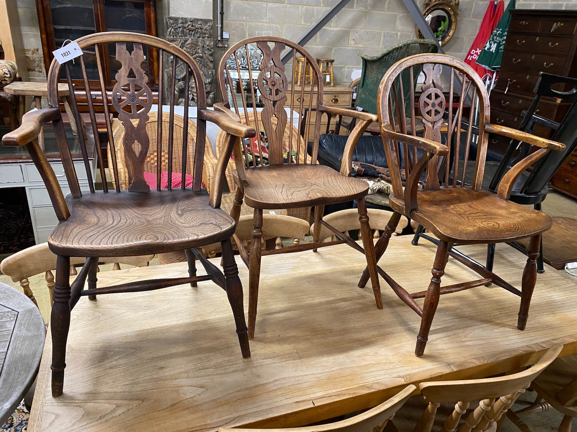 Three Victorian beech, ash and elm wheel back Windsor chairs